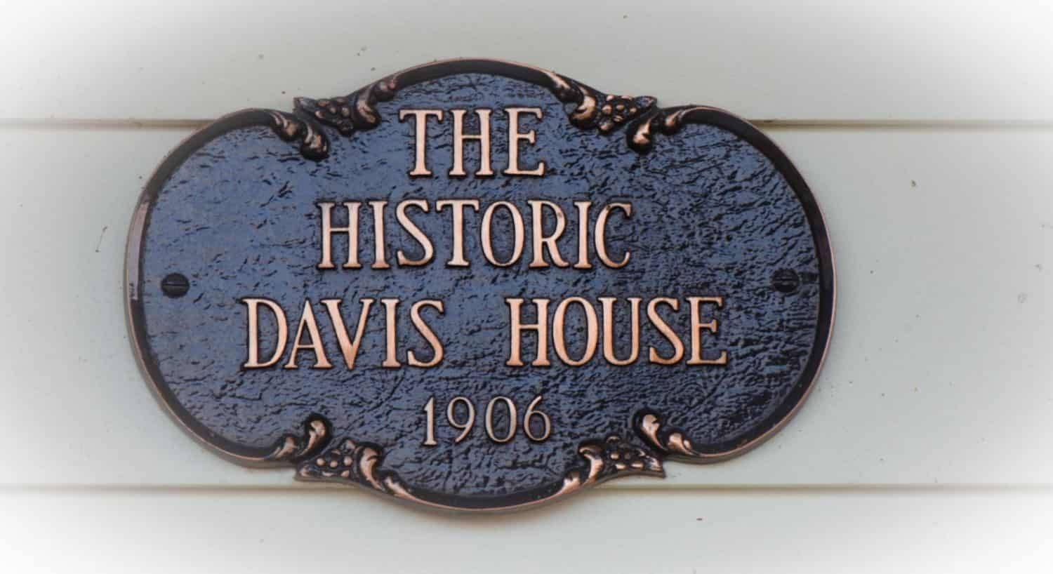 Antiqued bronze sign saying The Historic Davis House 1906